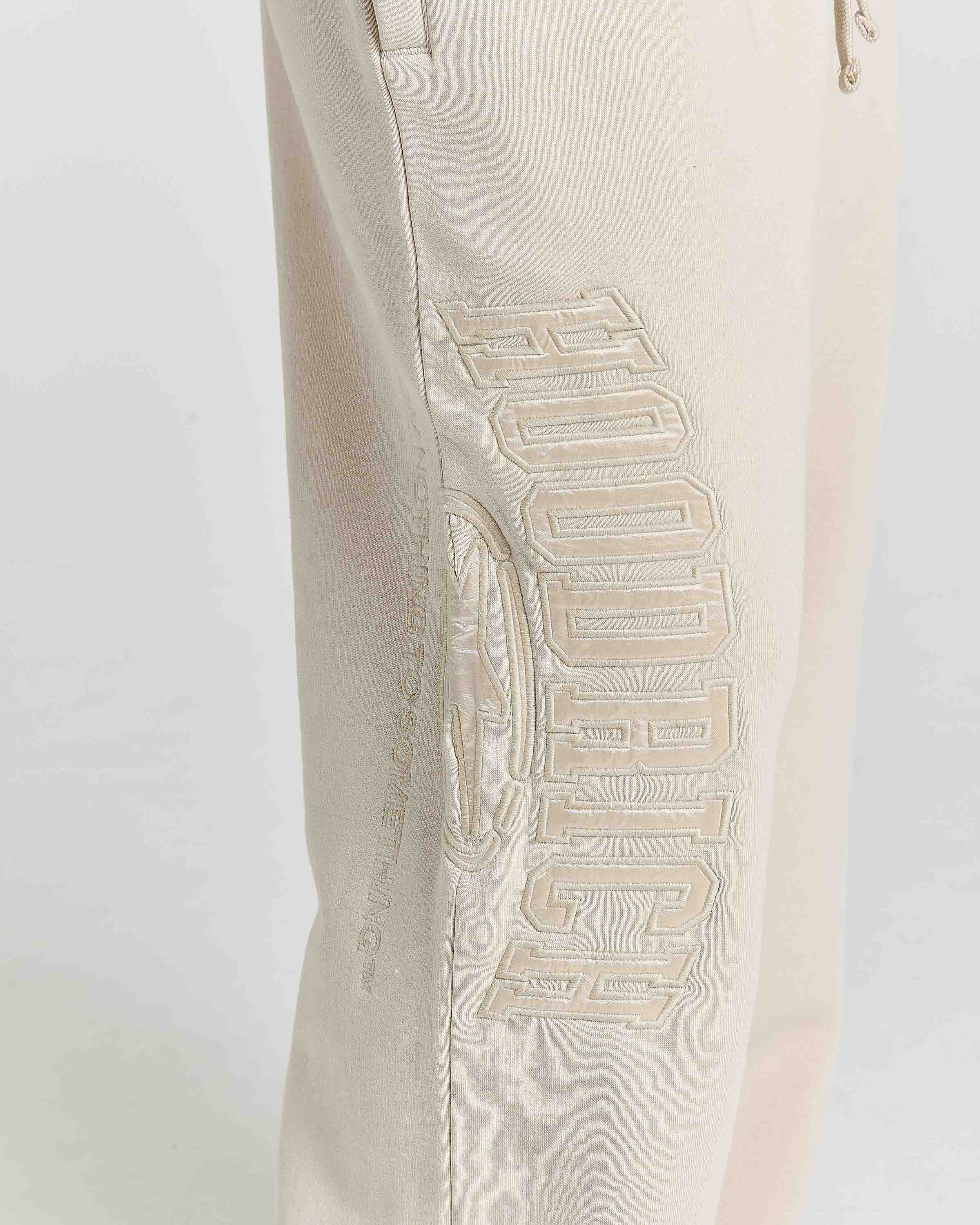Displays a model wearing the Stone 'Hoodrich' branded women's Aegis Full Tracksuit