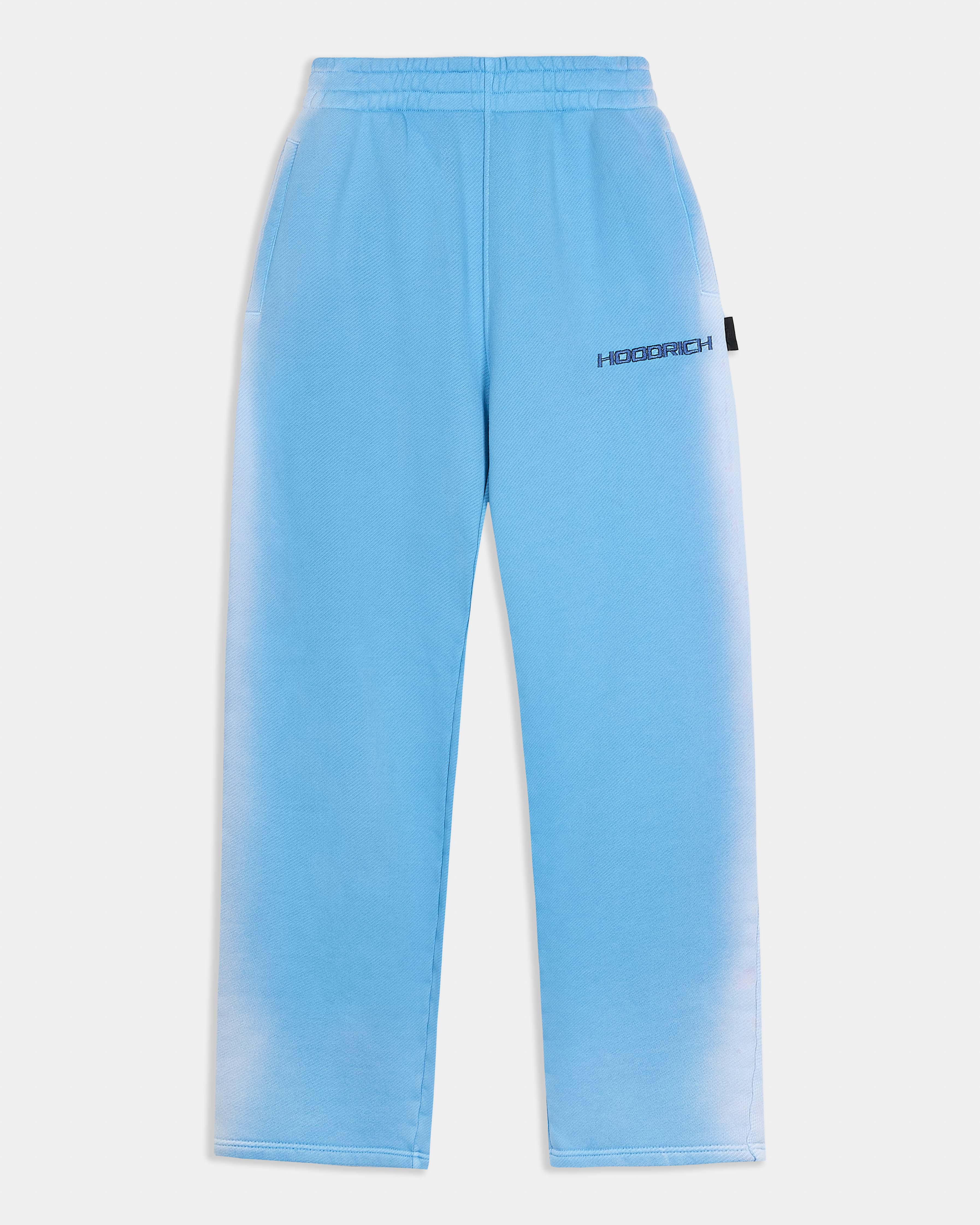 Oversized blue joggers featuring a black Hoodrich logo embroidery on the thigh.