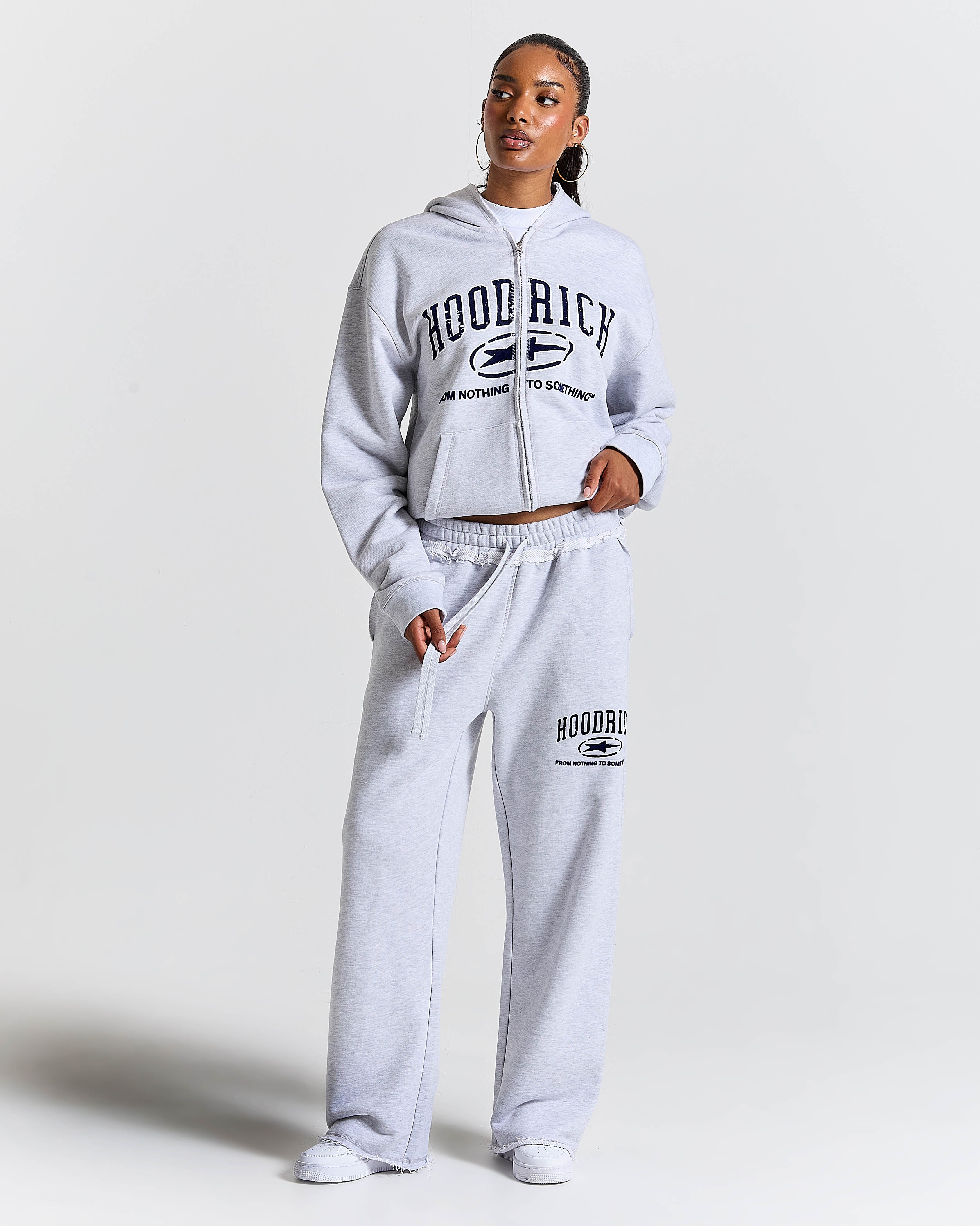 Displays a model wearing the Grey 'Hoodrich' branded Women's Frey Full Tracksuit