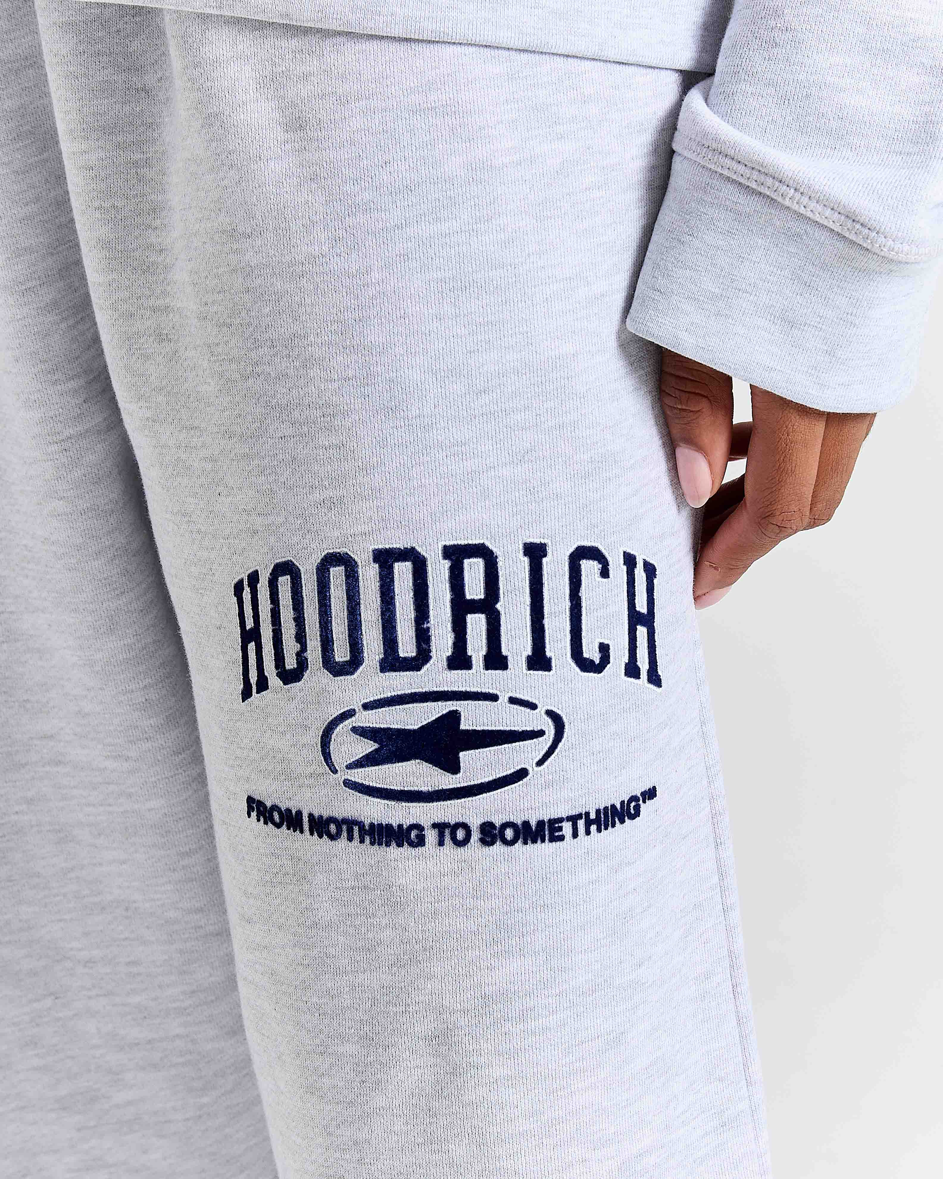 Gray sweatpants with 'Hoodrich' logo and text on a light background