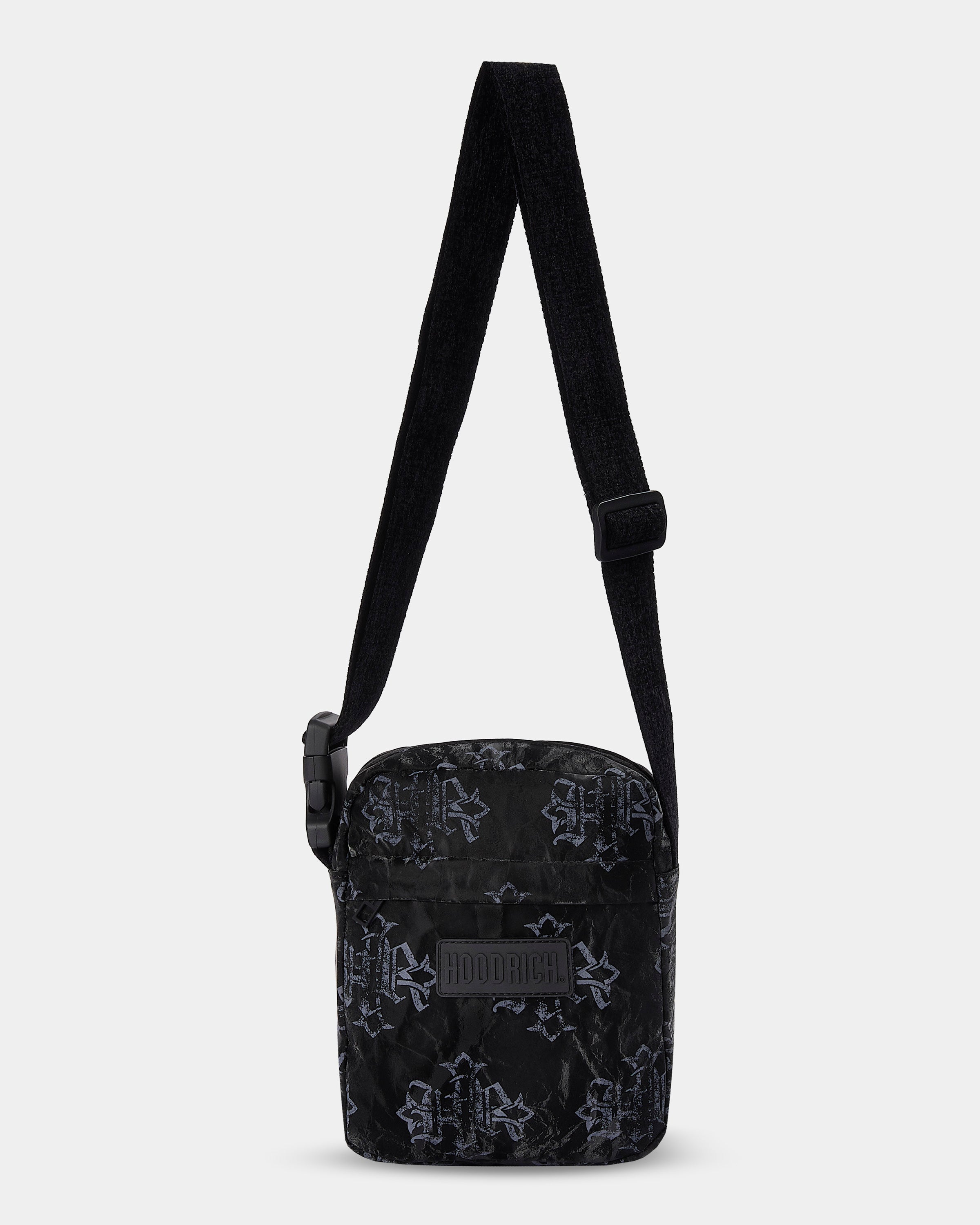 Black patterned crossbody bag on a light gray background