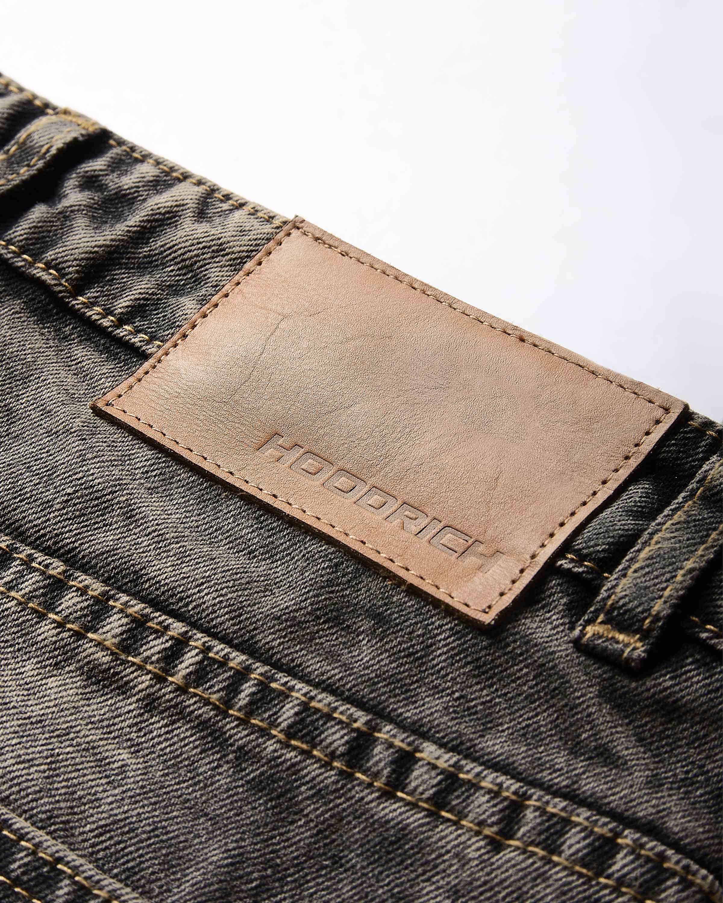 Close-up of a denim fabric with a leather label on a white background