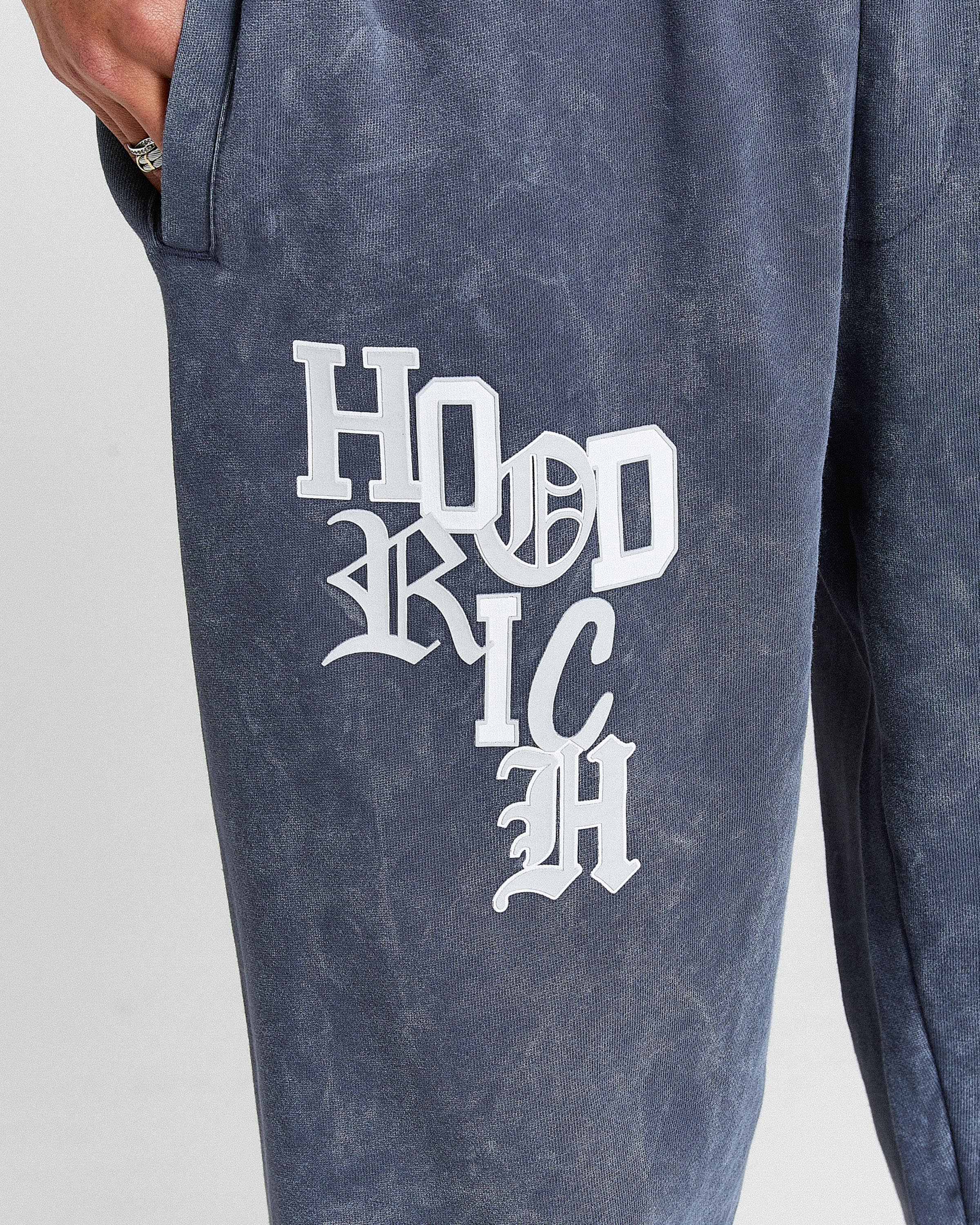 Displays a model wearing the Blue & white 'Hoodrich' branded Heritage Full Tracksuit