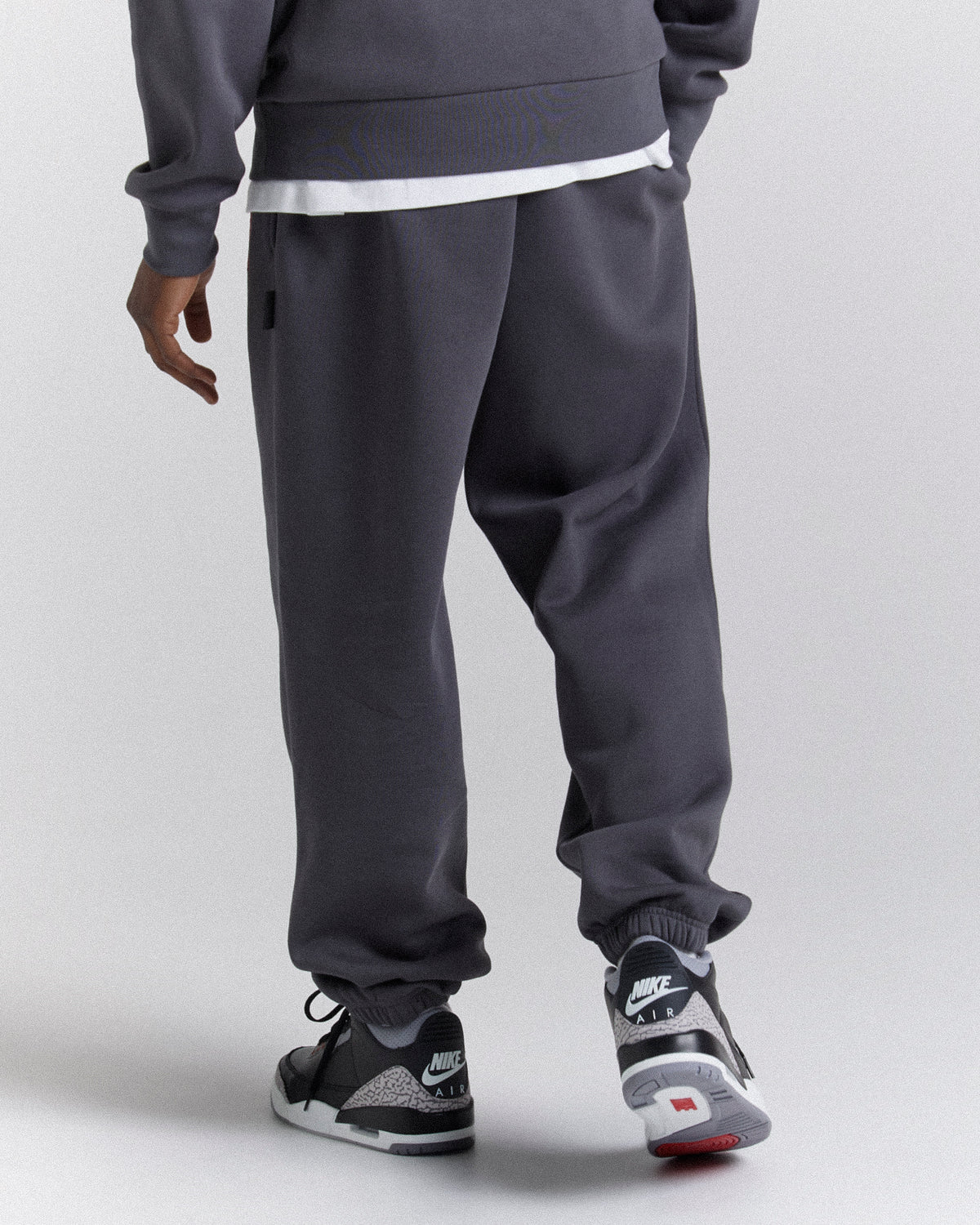 Displays a model wearing the Grey 'Hoodrich' branded men's Crown Full Tracksuit