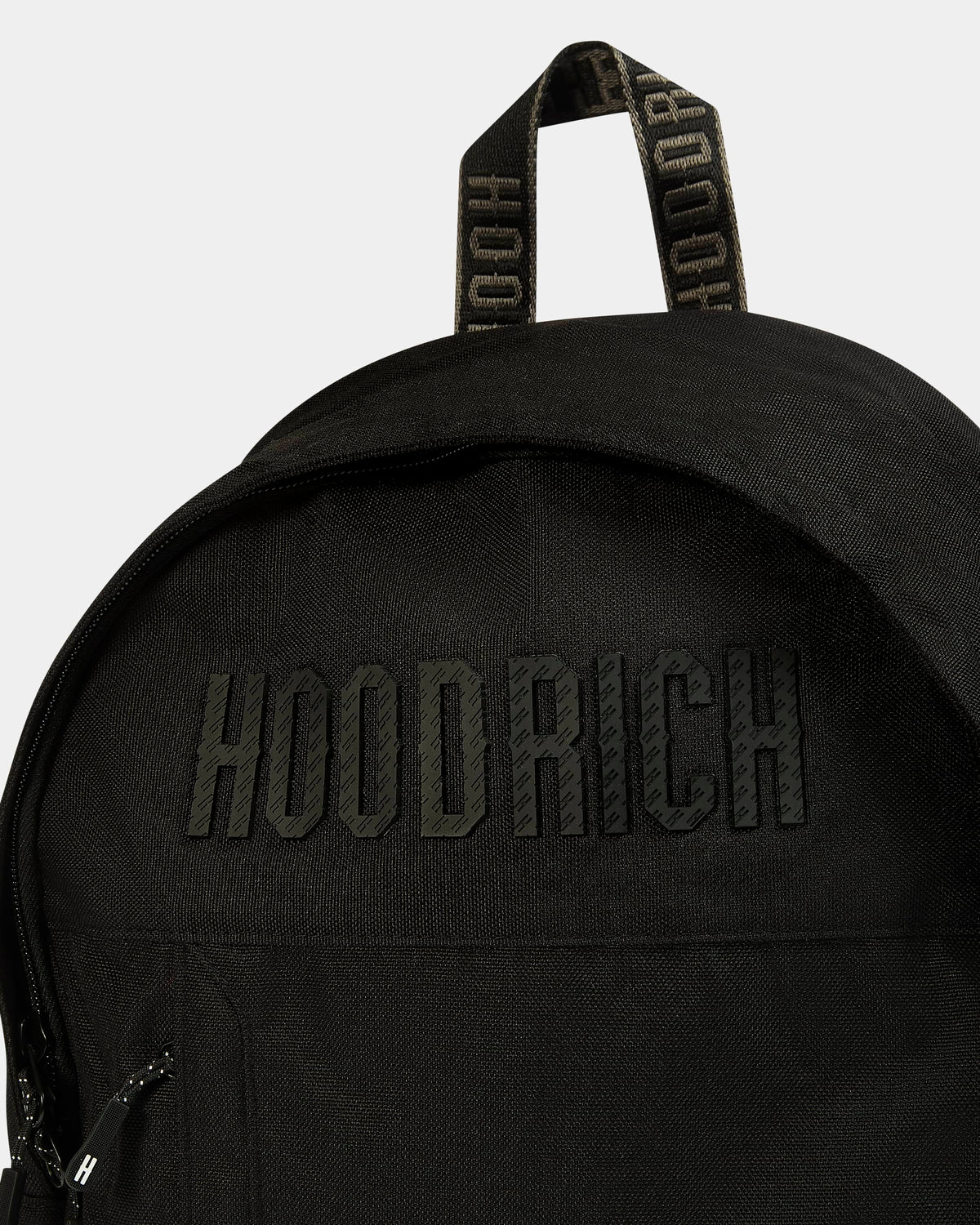 Close-up of a black backpack with a tonal black embroidered 'HOODRICH' logo on the front and a matching black top handle with 'HOODRICH' text, shown against a light gray background.