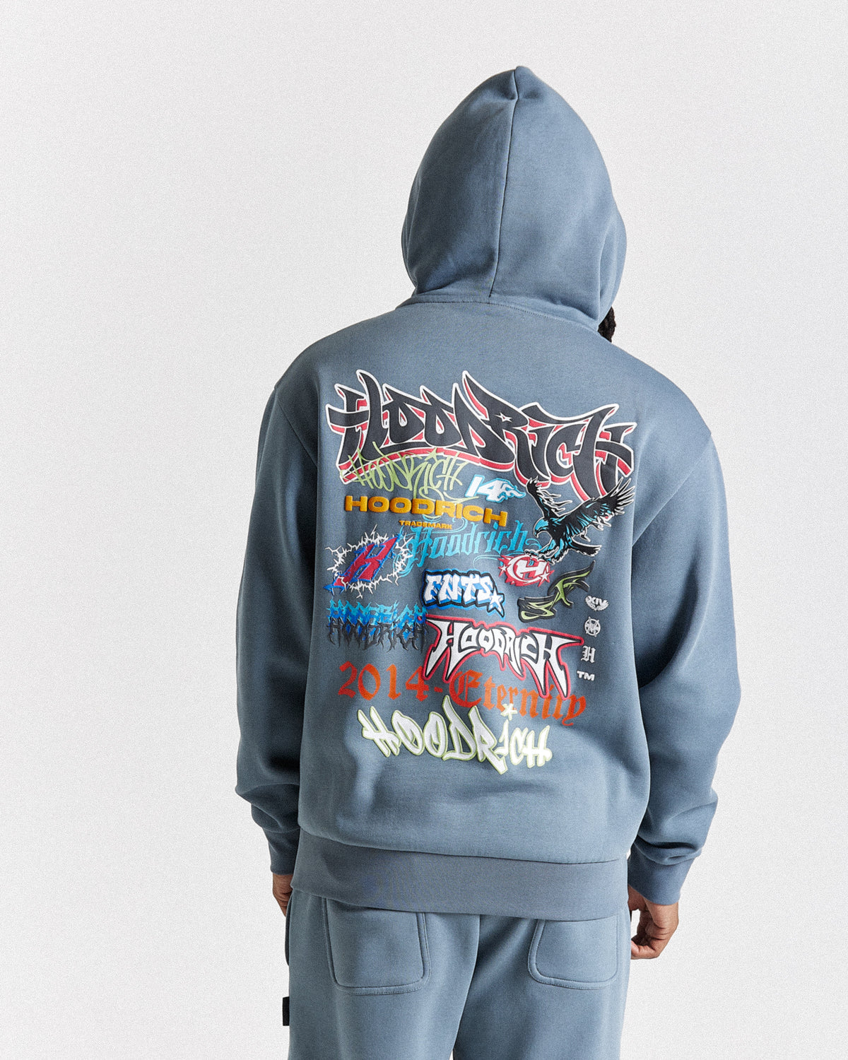 Displays a model wearing the Grey 'Hoodrich' branded men's Graff Rave Full Tracksuit