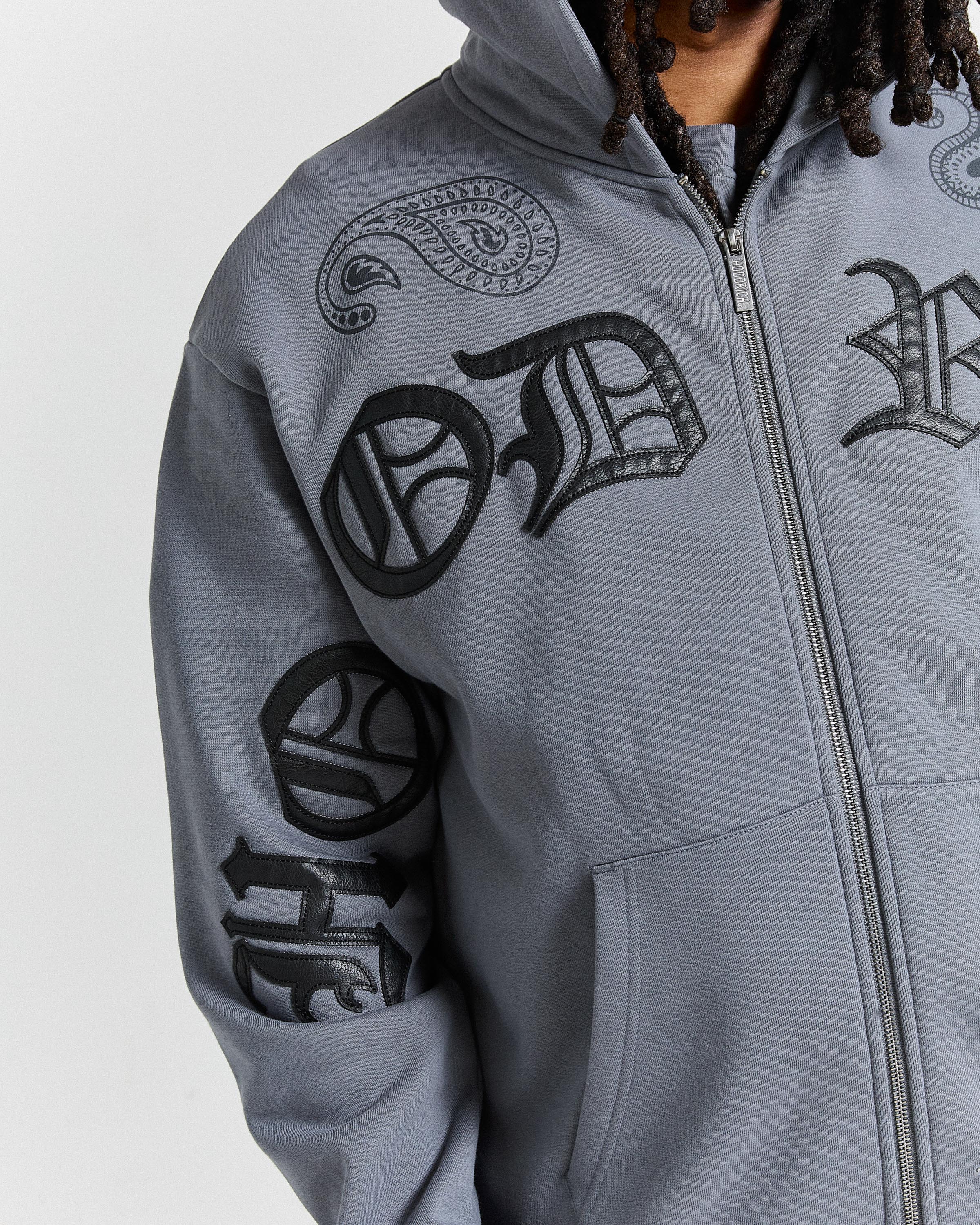 Gray hoodie with black tribal designs on a white background