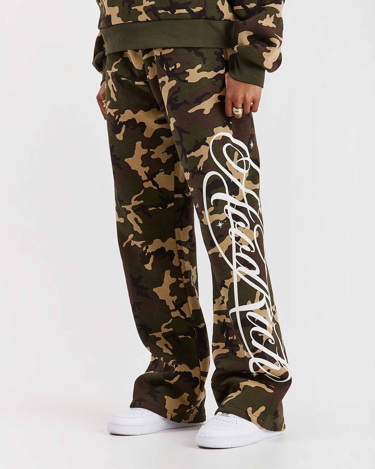 Displays a model wearing the Camo 'Hoodrich' branded women's Solace Full Tracksuit