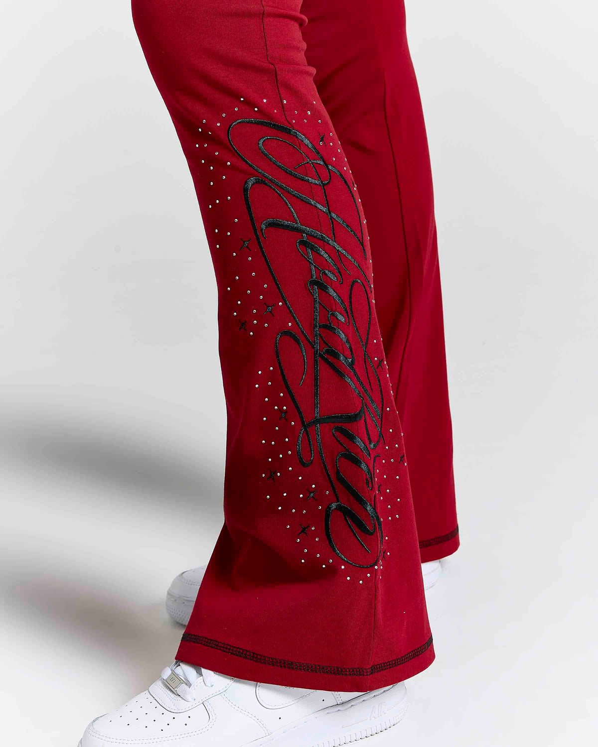 Displays a model wearing the red 'hoodrich' branded Gleam Flare Legging featuring the hoodrich branding details