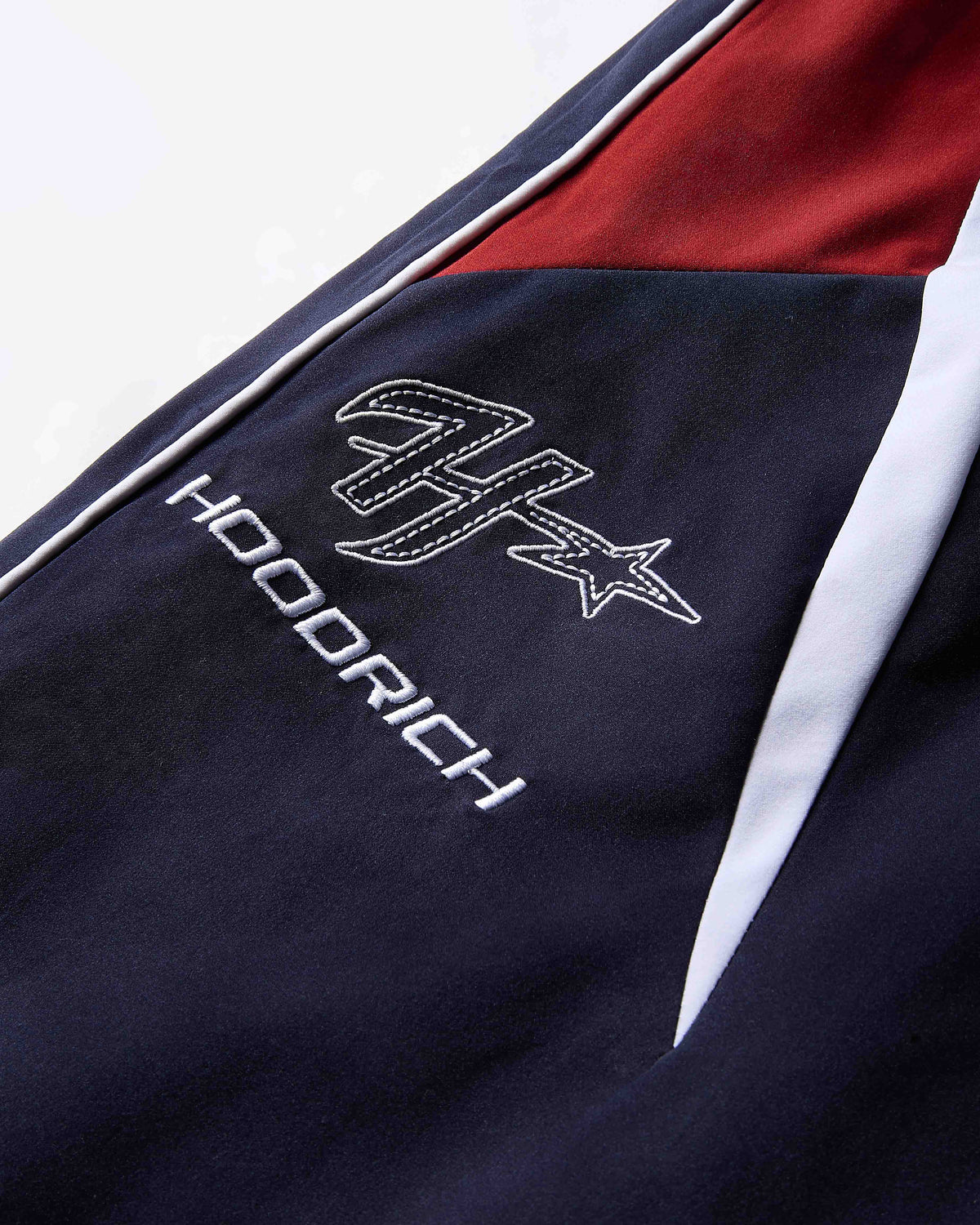 Navy blue jacket with white logo and text on a white background