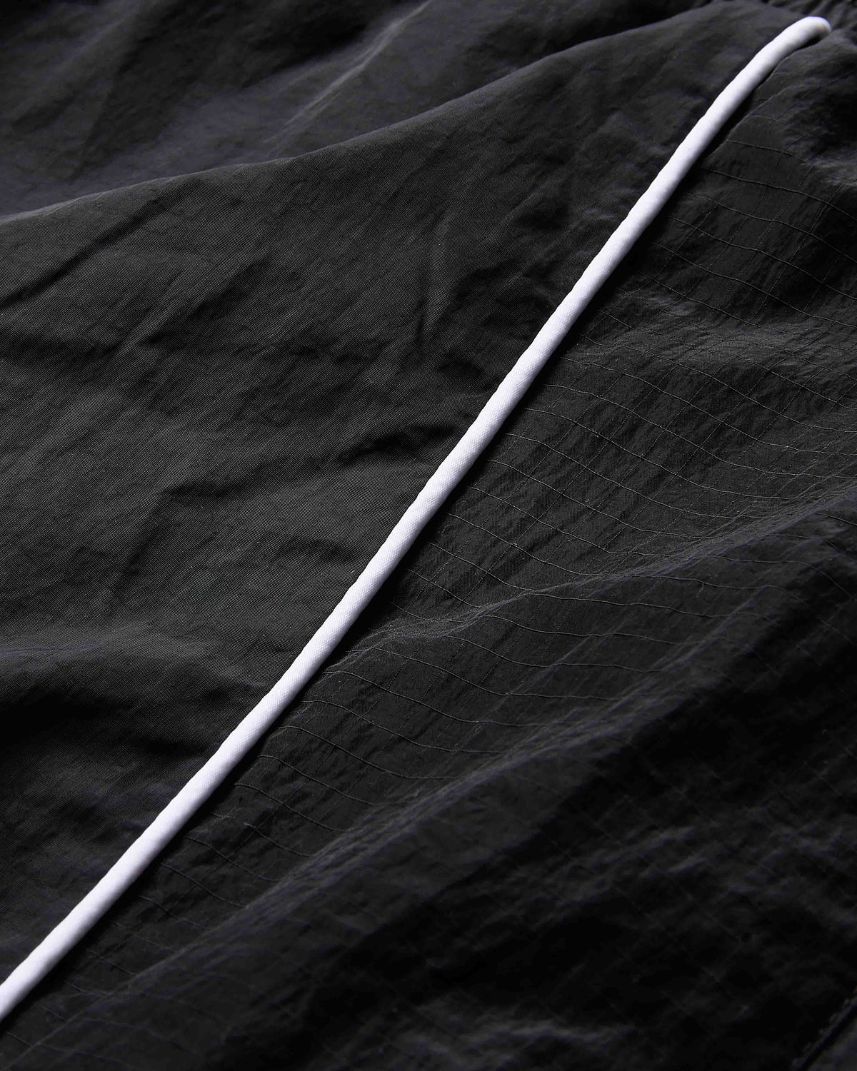 White cable on a black textured fabric background