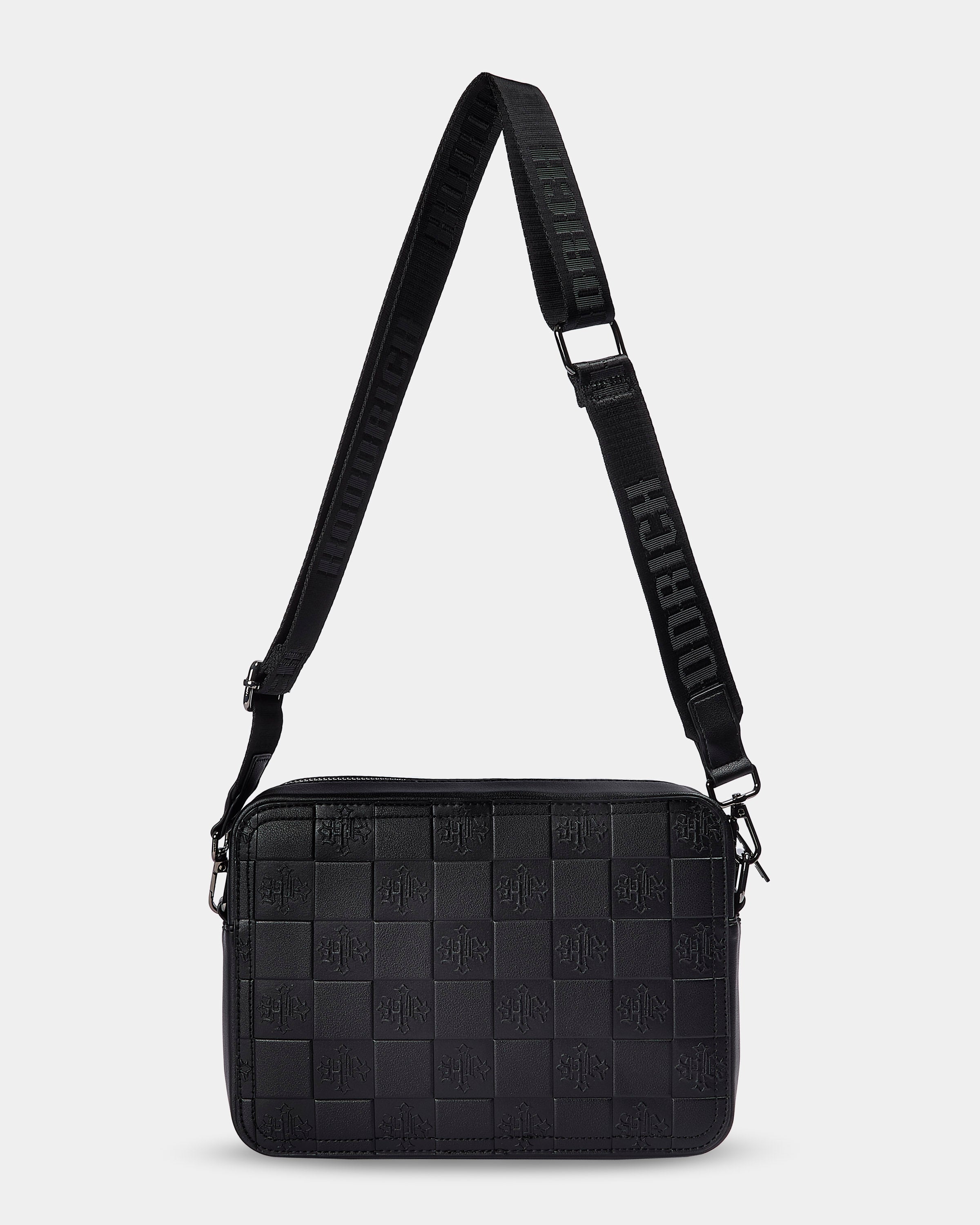 Black woven crossbody bag with a strap on a light gray background