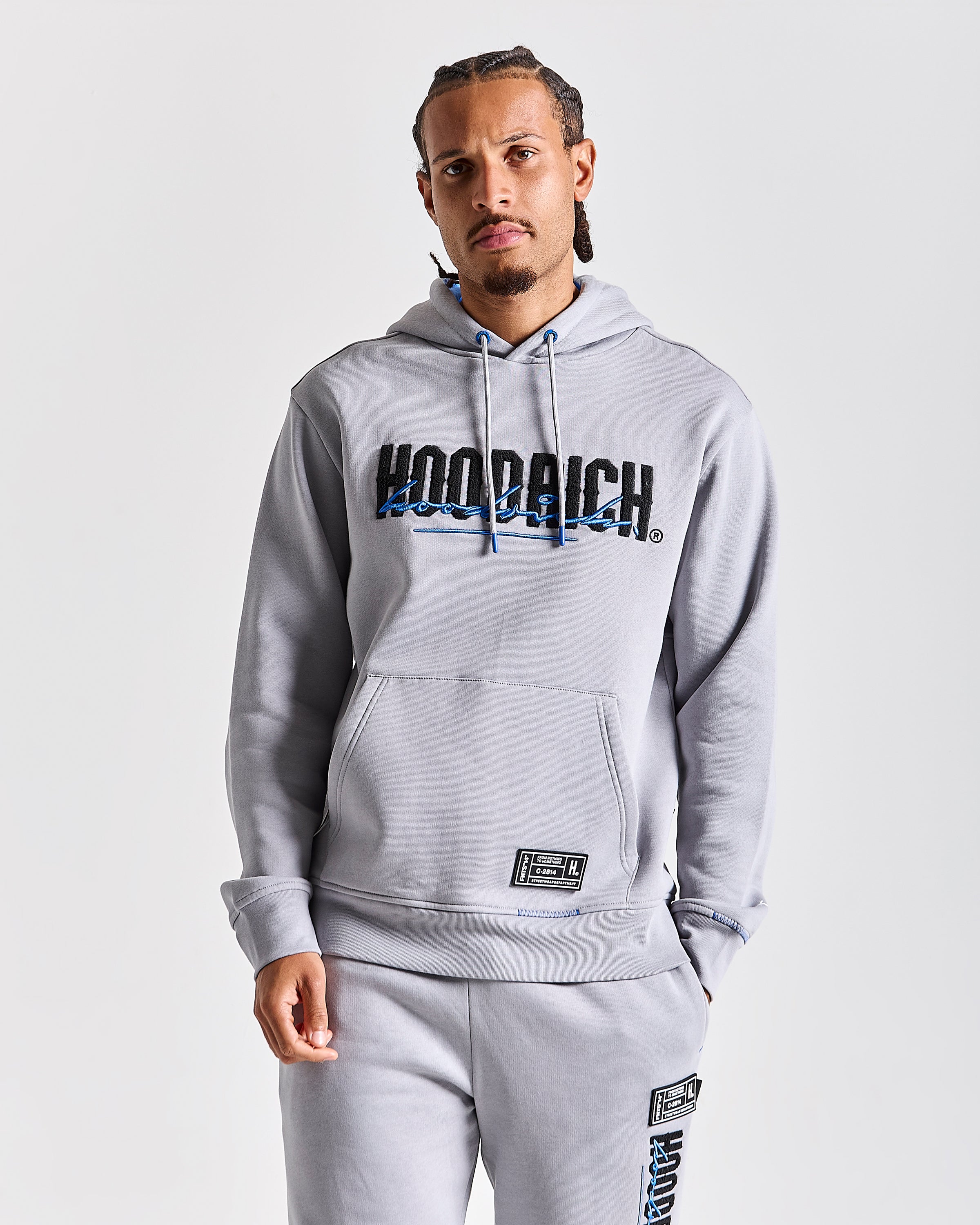 Displays a model wearing the Grey 'Hoodrich' branded men's blend Full Tracksuit 