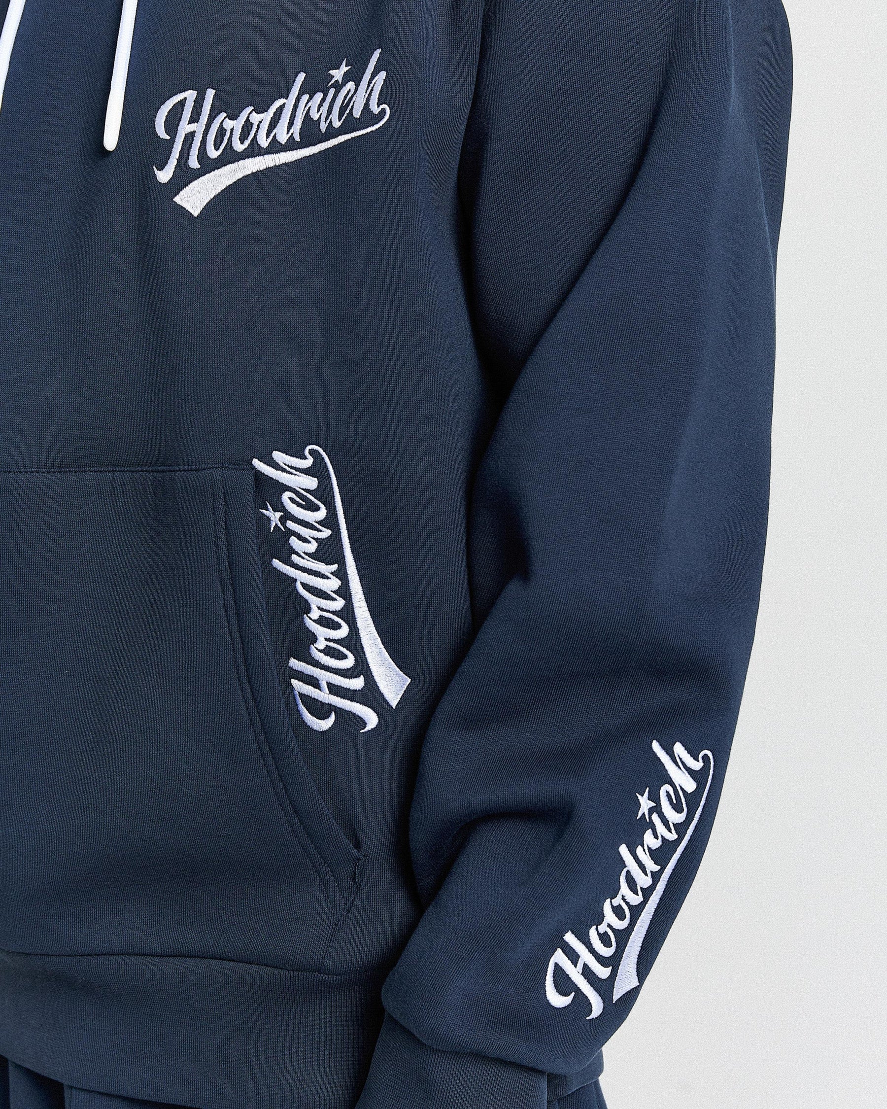 Navy blue hoodie with 'Hoodrich' logo on a light gray background