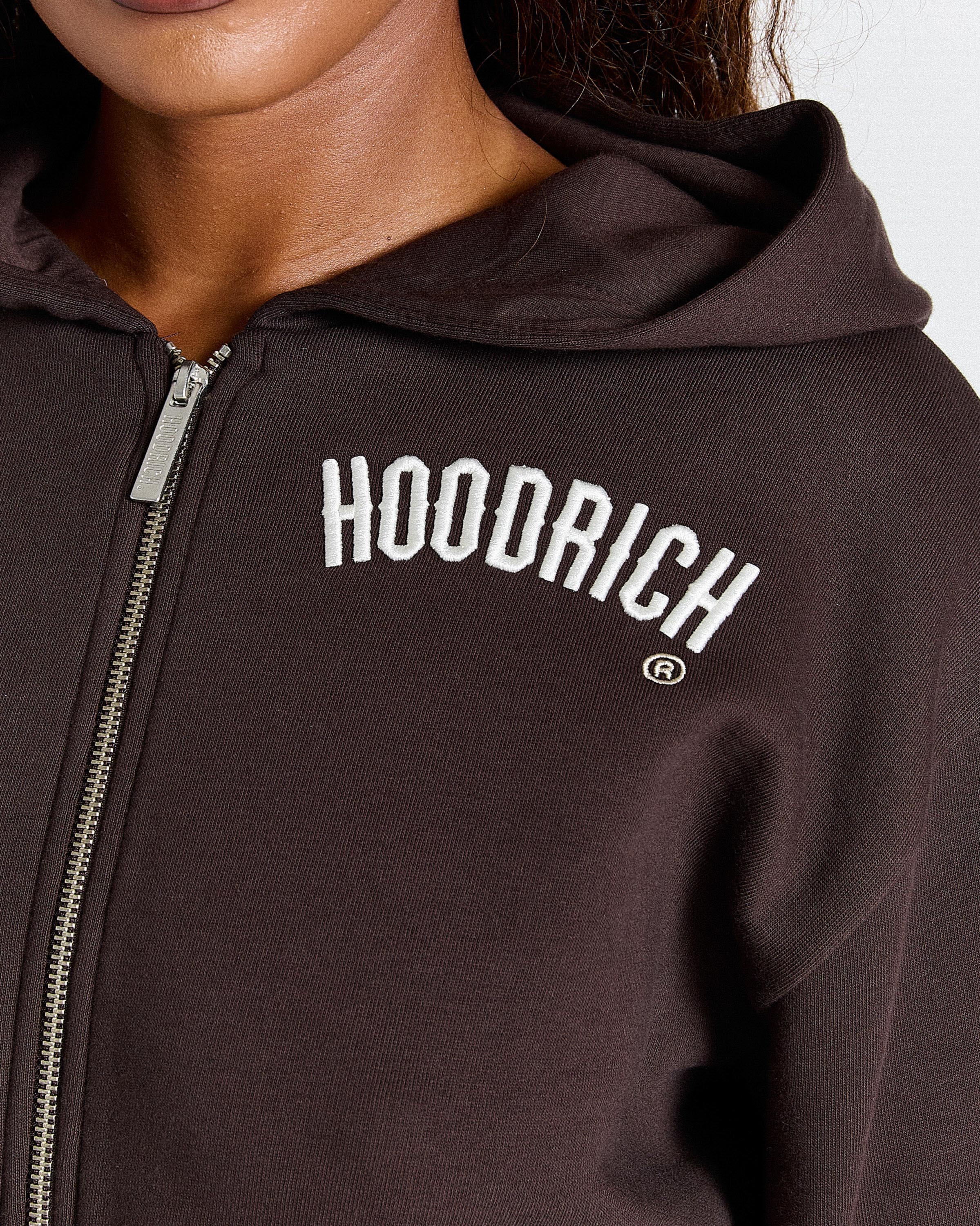 Brown hoodie with 'HOODRICH' logo on a white background