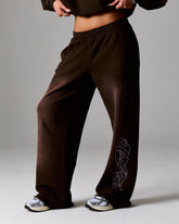 Brown sweatpants with a logo on a gray background