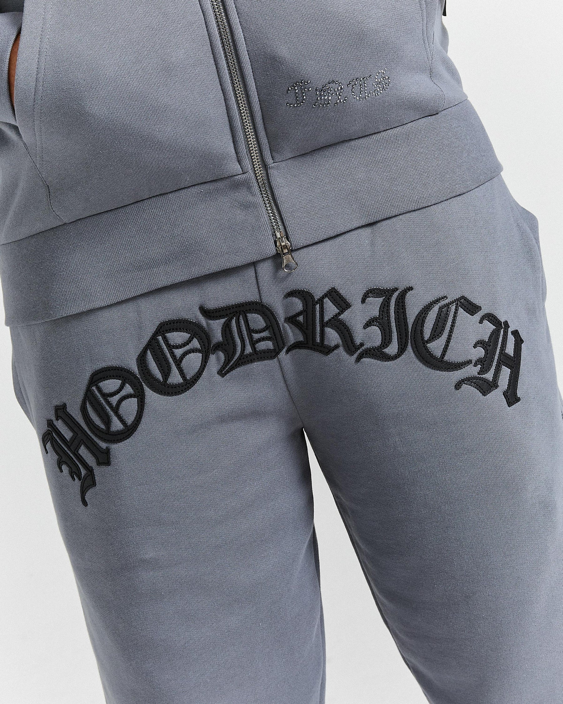 Gray tracksuit with 'Hoodrich' branding on a light gray background